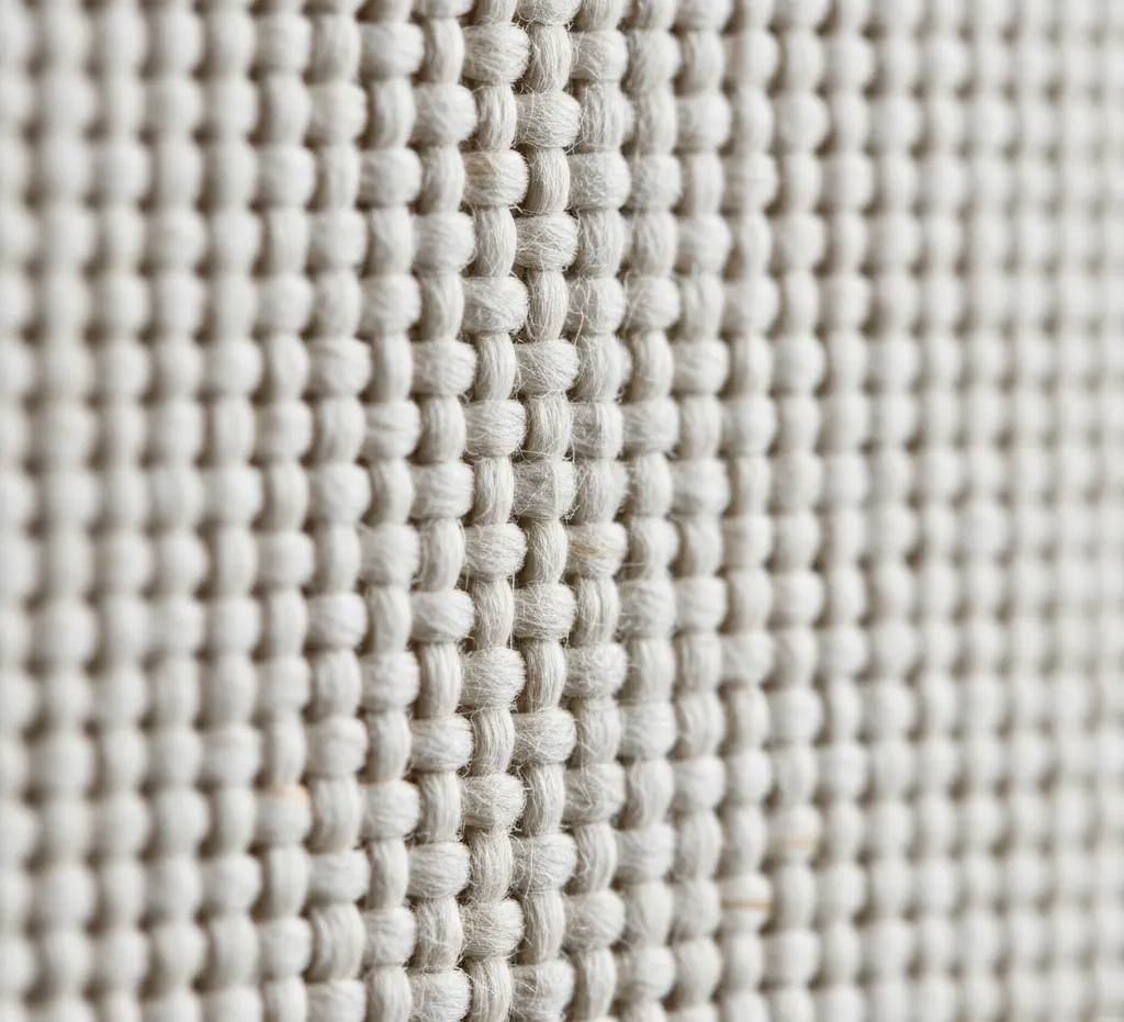 Extreme close-up of a premium cotton canvas texture, showing the tight, quality weave of the material suitable for fine art printing.